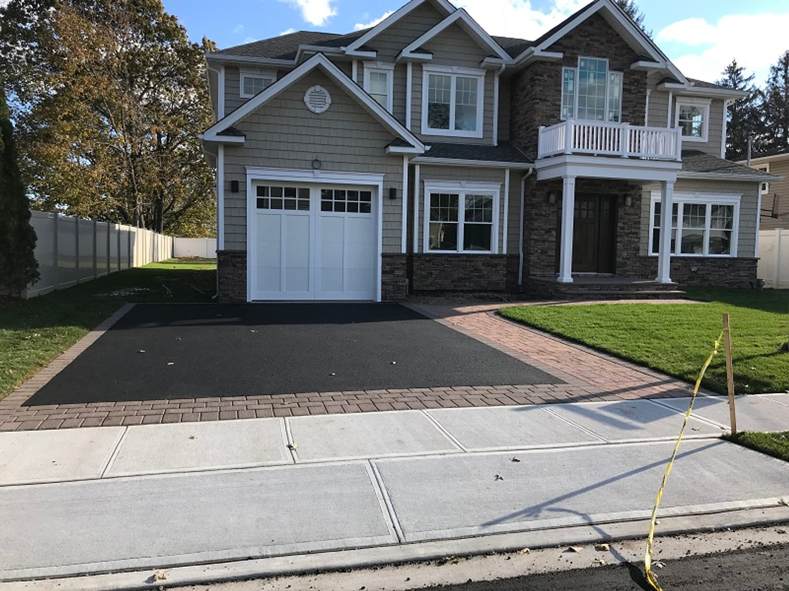 Paver driveway and brick apron in front of a Long Island colonial