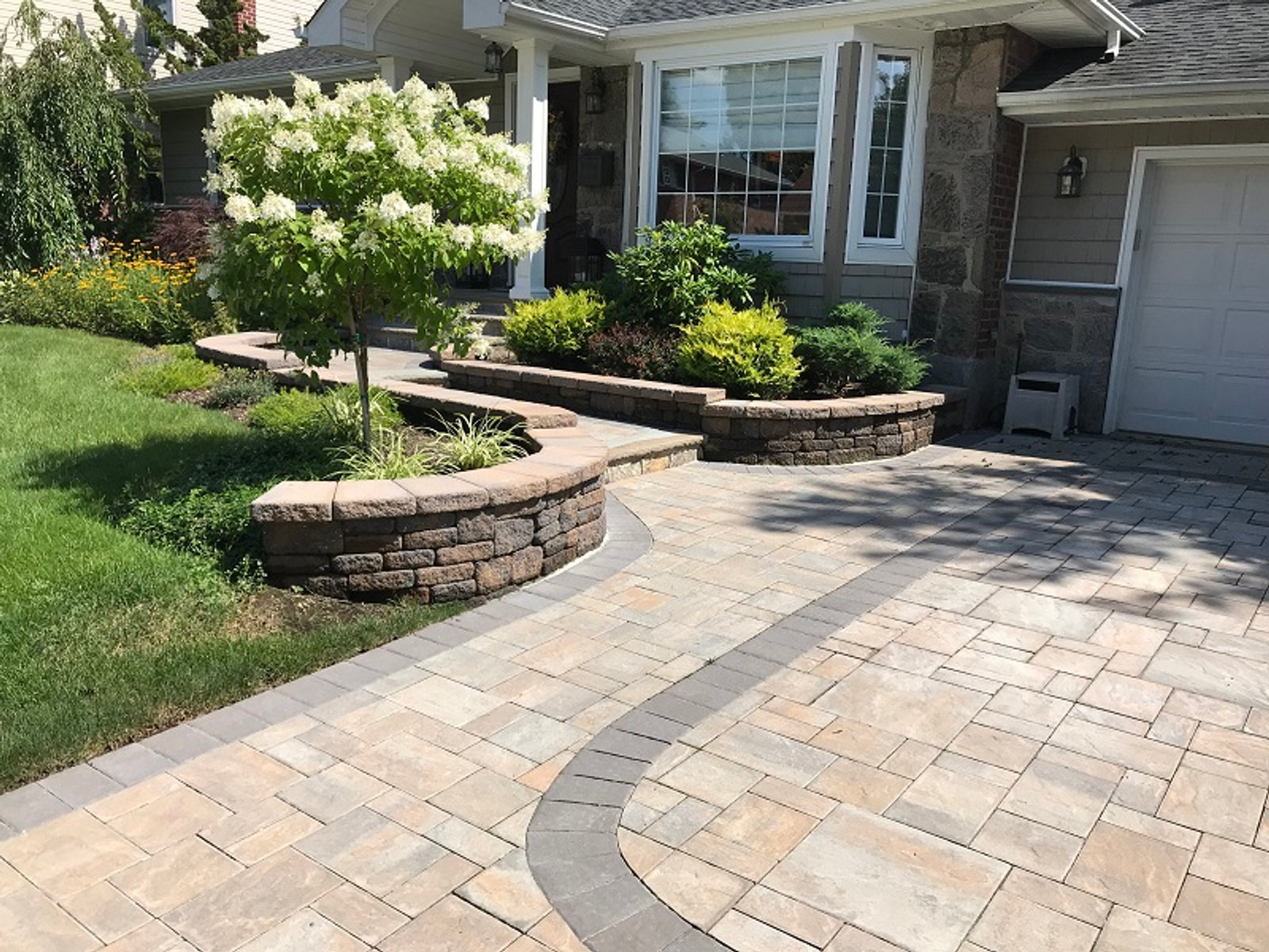 Long Island landscape and paver driveway built by Oraco Landscape Designer